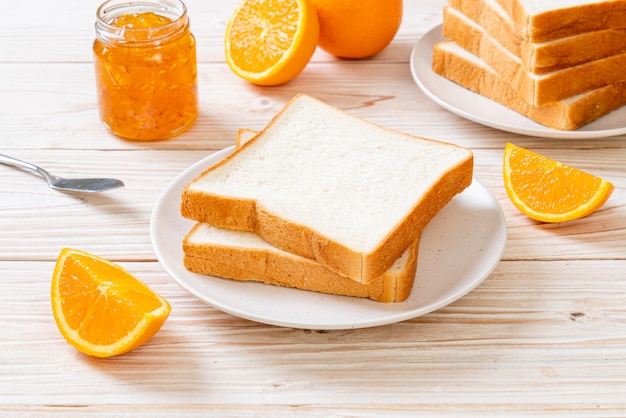 Premium Photo Slices Of Bread With Orange Jam