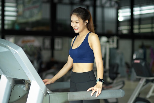 Premium Photo | Slim fit fitness girl enjoying exercising on treadmill ...