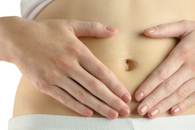 Slim woman touching her belly Premium Photo
