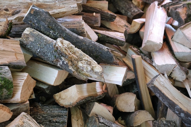 Premium Photo | Small brown chopped firewood with grey bark pile lies