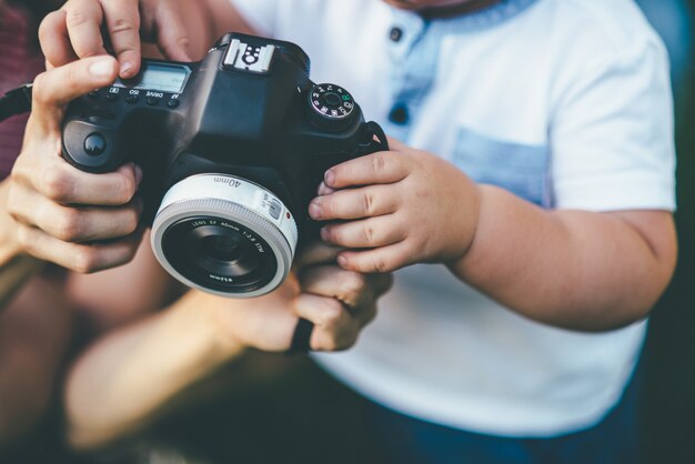 Premium Photo | Small child holding a camera