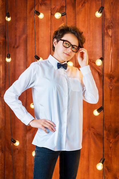 Premium Photo | Smart teenager wearing glasses posing in loft apartment ...