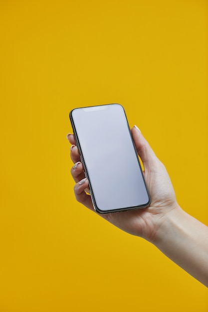 Premium Photo Smartphone Mockup Female Hand Holding Black Cellphone With With Blank Display On Yellow Background