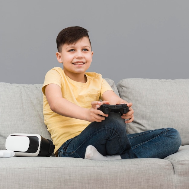 Free Photo | Smiley boy playing video games