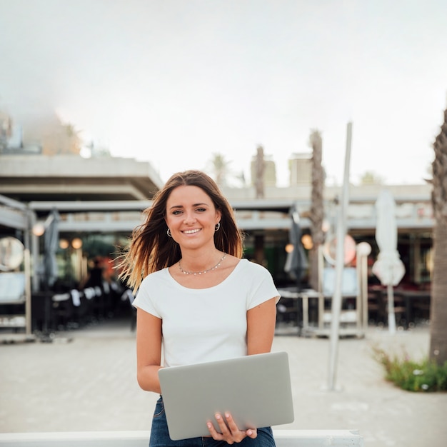 Smiley Girl With Notebook Looking At Camera Phot