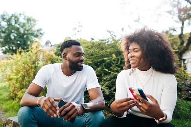 Free Photo | Smiley intercultural friends sitting on bench