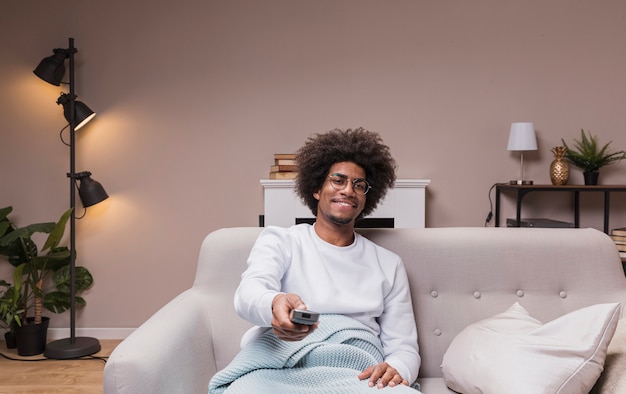 Premium Photo | Smiley man changing tv channels