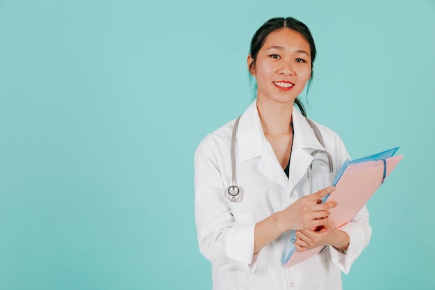 Free Photo | Smiling asian doctor with stethoscope and folder