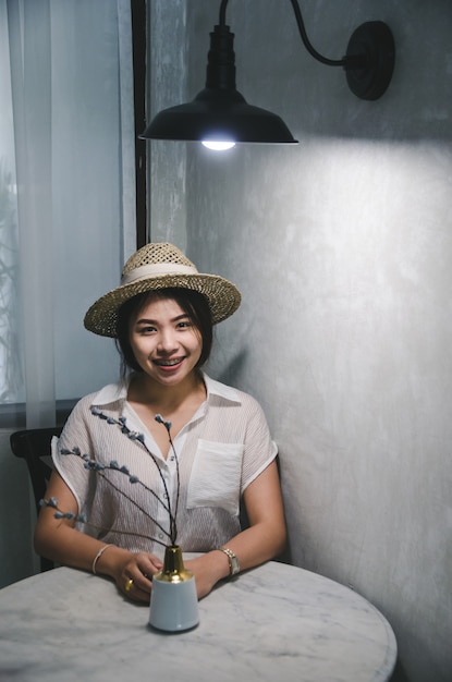 Premium Photo Smiling Asian Women Sitting In Living Room With Dark Light
