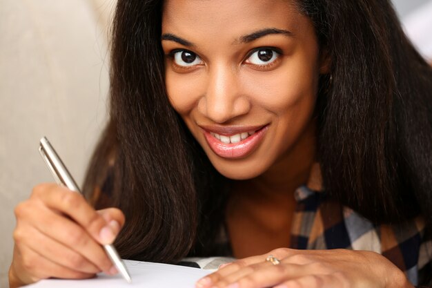 Premium Photo Smiling Black Woman Write Story In Notebook 7569