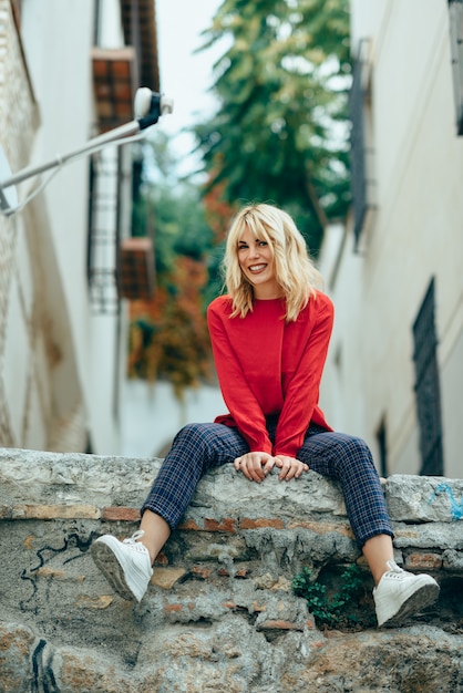 Premium Photo | Smiling blonde girl with red shirt enjoying life outdoors.