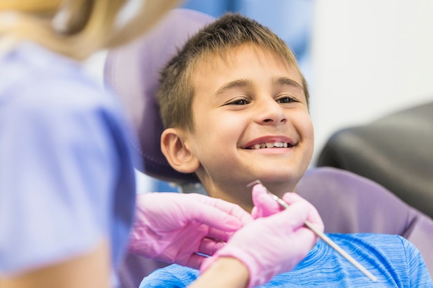 Smiling boy going through dental treatment in clinic