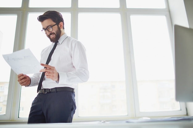 Free Photo | Smiling businessman holding a sketch