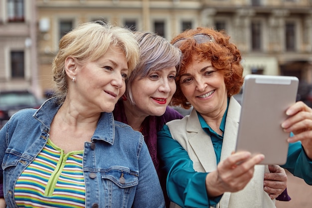 Premium Photo Smiling Caucasian Middle Aged Females Are Taking Selfie