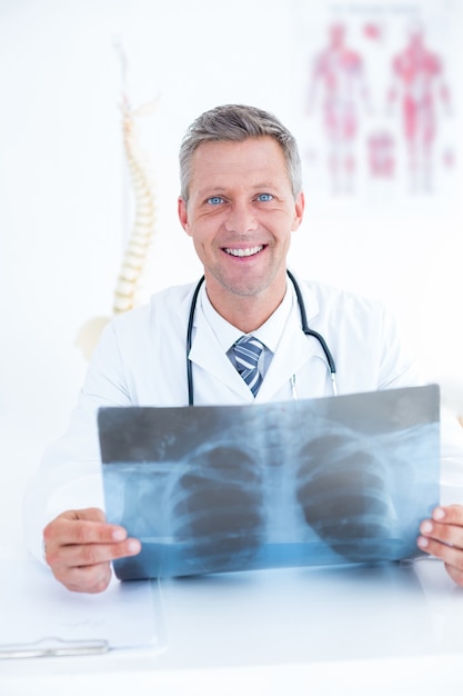 Premium Photo | Smiling doctor holding xray