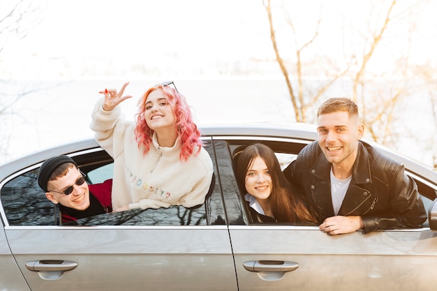 Smiling Friends Looking Out Of Car Window Photo Free Download