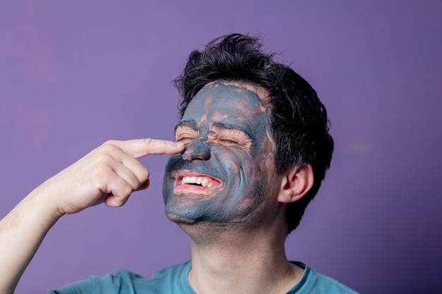 Premium Photo | Smiling guy in a face care mask