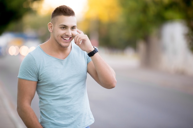 Smiling guy walking down the street Photo | Free Download