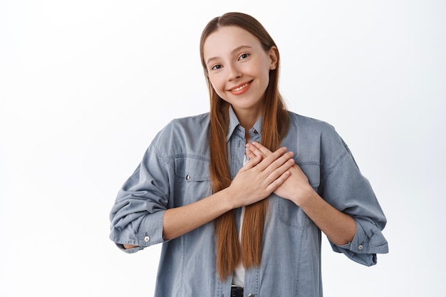 Premium Photo Smiling Heartfelt Girl Say Thank You Holding Hands On Heart And Sighing Being