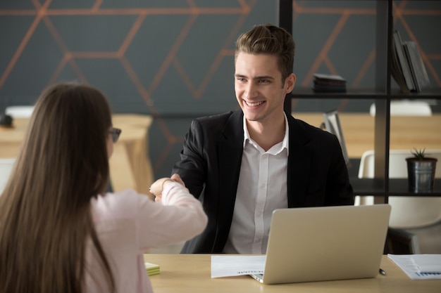 Smiling hr employer handshaking successful job applicant hiring or greeting Free Photo