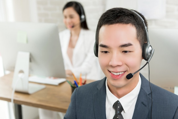 Premium Photo | Smiling male asian customer service telemarketing agent ...