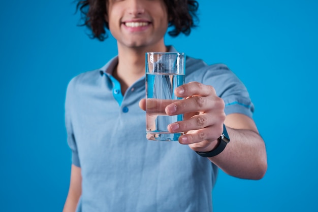 Premium Photo Smiling Man Holding A Glass Of Water In His Hand 9716