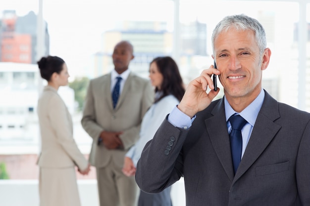 Premium Photo Smiling Manager Talking On The Mobile Phone While His