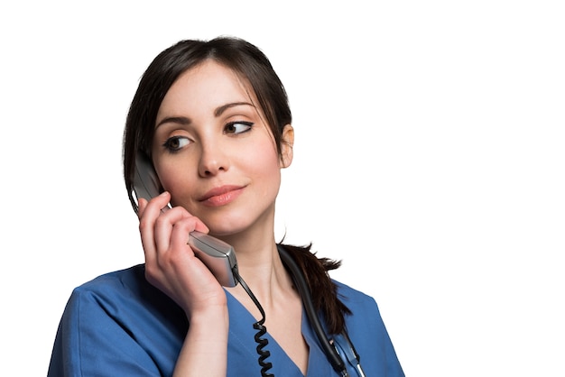 Premium Photo | Smiling nurse talking on the phone