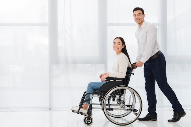 smiling-portrait-young-man-pushing-disabled-woman-sitting-wheelchair-looking-camera_23-2148127385.jpg (626×417)