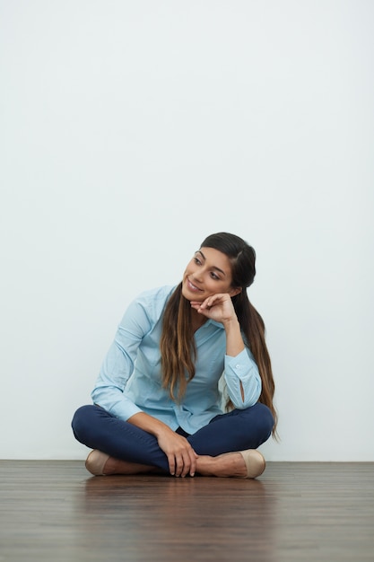 Free Photo | Smiling relaxed beautiful woman sitting on floor