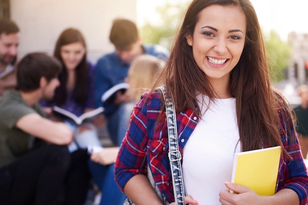 Smiling woman having a break at university Free Photo