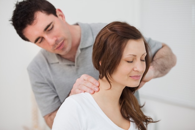 Premium Photo | Smiling woman sitting while being massaged by a man