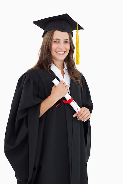 Premium Photo | A smiling woman with her degree as she looks at the camera