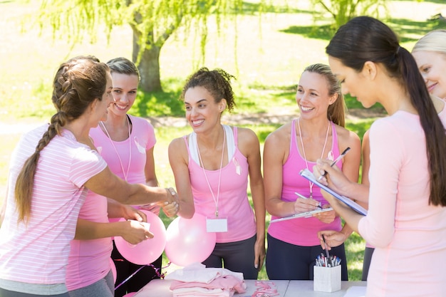 Premium Photo Smiling Women Organising Event For Breast Cancer Awareness