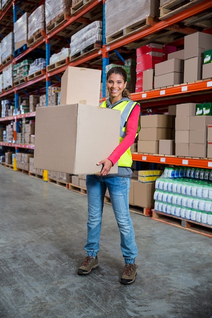 Premium Photo | Smiling worker holding boxes