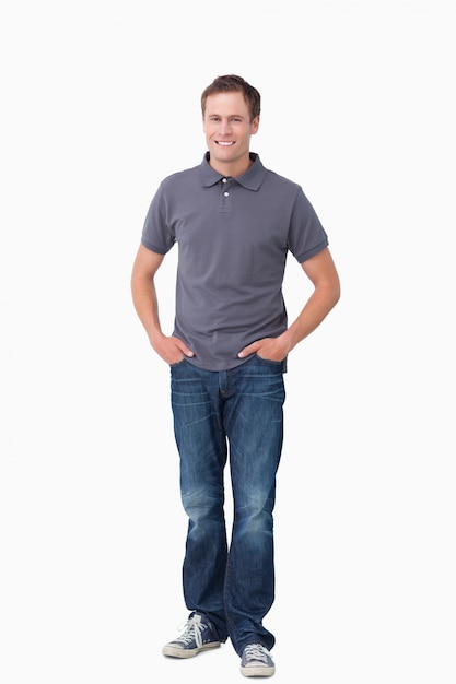 Premium Photo | Smiling young man with hands in his pockets