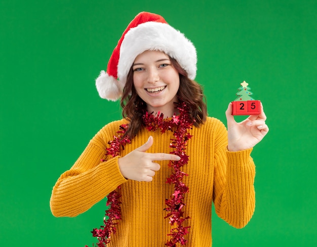 Free Photo | Smiling young slavic girl with santa hat and with garland ...