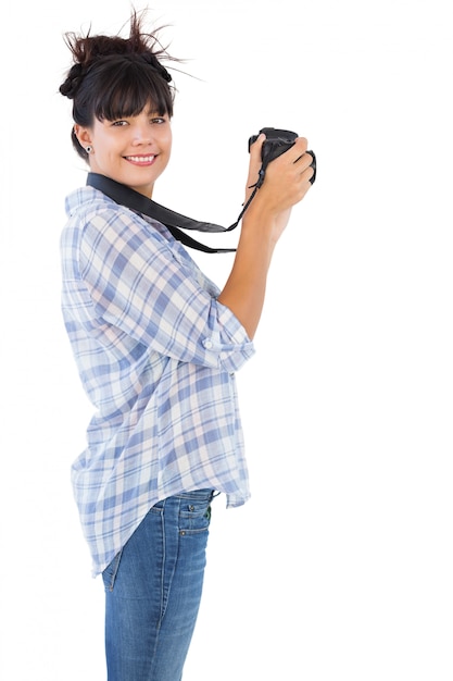 Smiling young woman taking picture with her camera Premium Photo
