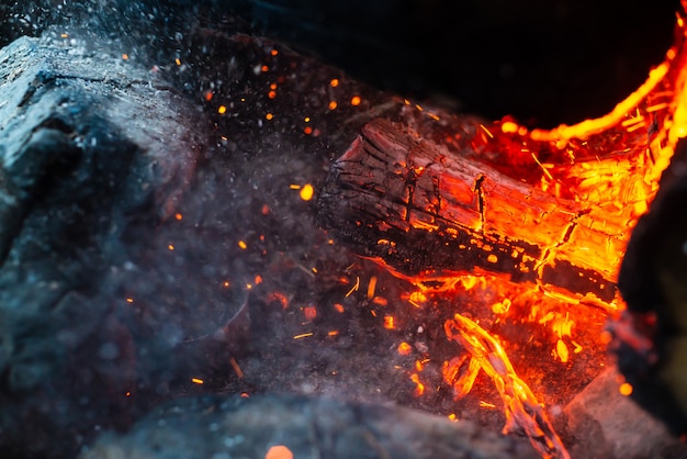 Premium Photo Smoldered Logs Burned In Vivid Fire Close Up