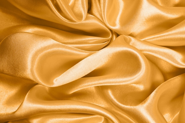 Premium Photo | Smooth elegant gold silk or satin texture can use as ...