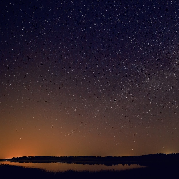 Premium Photo | Smooth surface of the lake on a background the starry sky