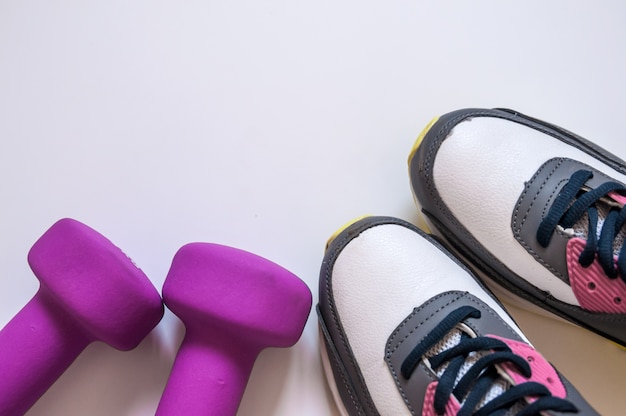 Sneakers And Dumbbells Fitness On A White Background