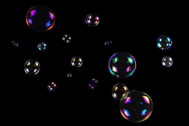 Premium Photo | Soap bubbles isolated on a black background. copy space.