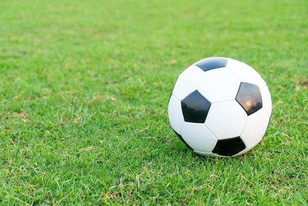 Premium Photo | Soccer ball on the football field background with copy ...