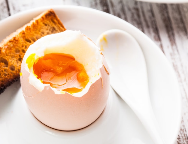 Premium Photo The Soft Boiled Egg In An Eggcup With Toasted Bread