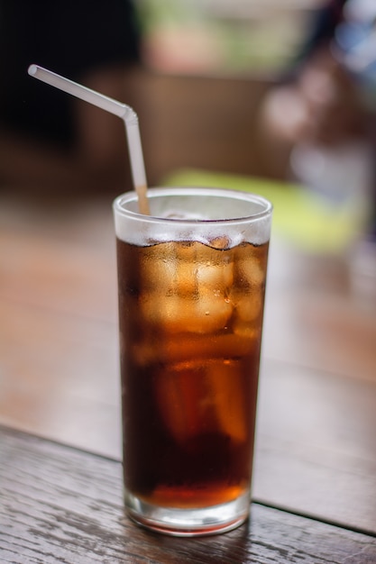 Download Soft drink with ice in the glass on a table. | Premium Photo