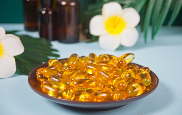 Premium Photo Soft Gelatin Capsules Natural Vitamins Supplement Vitamin A E Fish Oil Primrose Oil Tropical Surface