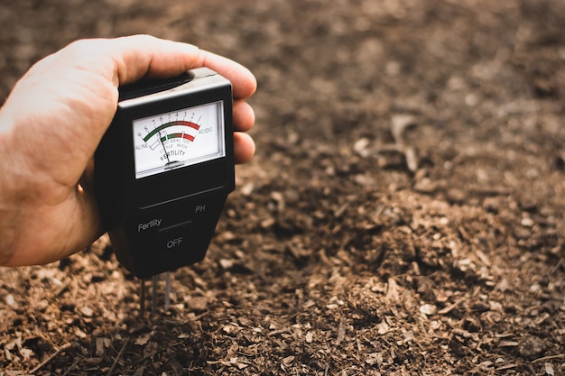 Premium Photo | Soil meter is used on loam for planting, measure soil ...