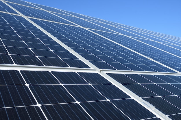 Premium Photo Solar Panels Against Blue Sky Background Against The Deep Blue Sky In Suny Weather