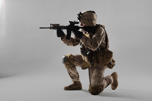 Soldier in camouflage holding rifle Premium Photo